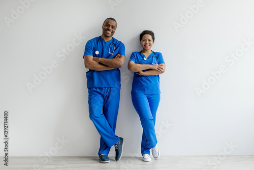 Fotografie Portrait of two African American healthcare professionals in blue scrubs, confid