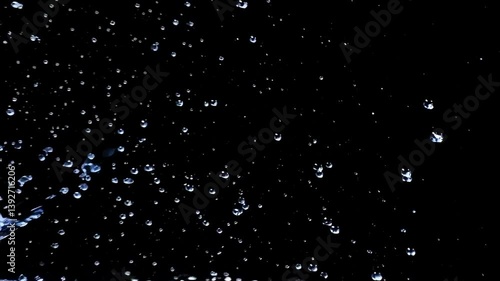 Ephemeral Dance of Droplets: A mesmerizing display of water droplets suspended against a dark, velvety canvas. The image captures a transient moment of pure, ethereal beauty.
