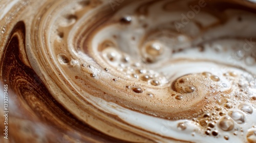 Swirling Cocoa: A close-up shot of a decadent cocoa drink reveals intricate swirling patterns of creamy foam, capturing the textures and colors.