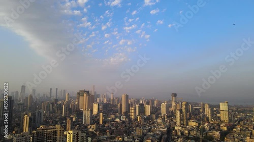 Drone shot of dramatic clouds over Mumbai city skyline while being chased by eagles