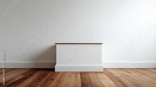 Minimalist interior design featuring a simple white wall and wooden flooring with a low ledge.