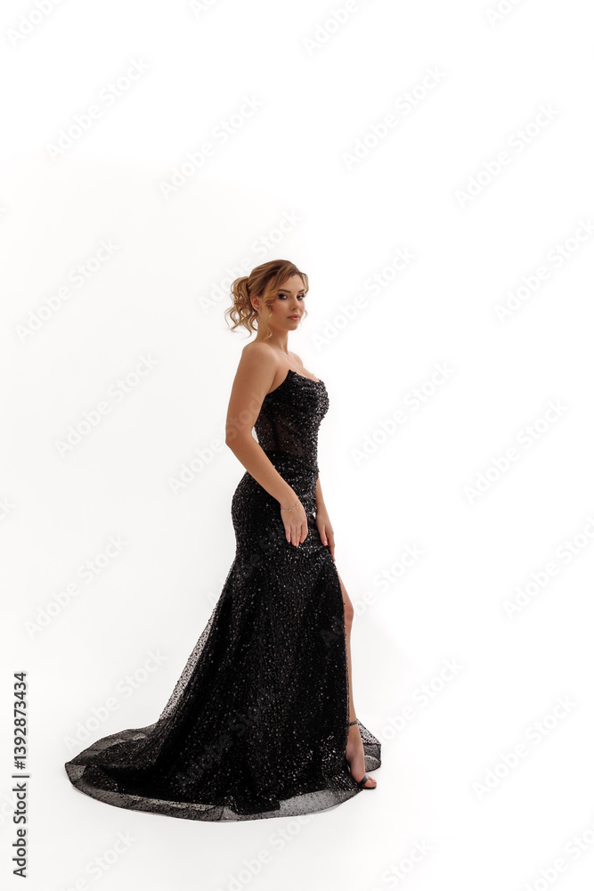 Elegant woman in a sparkling black gown posing gracefully in a studio setting Elegant woman in a sparkling black gown posing gracefully in a studio setting