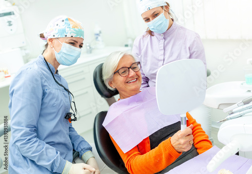Senior woman admiring her smile after dental checkup