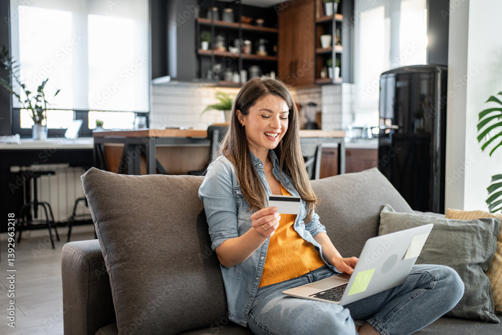 Happy woman using laptop and credit card for online shopping at home Happy woman using laptop and credit card for online shopping at home