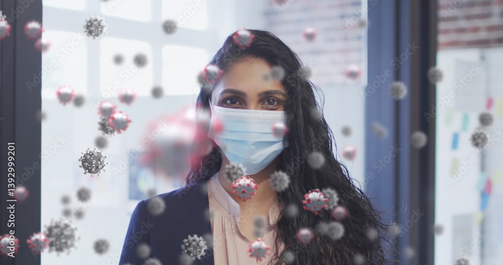 Φωτογραφία Image of covid 19 cells floating over portrait of biracial woman wearing face ma