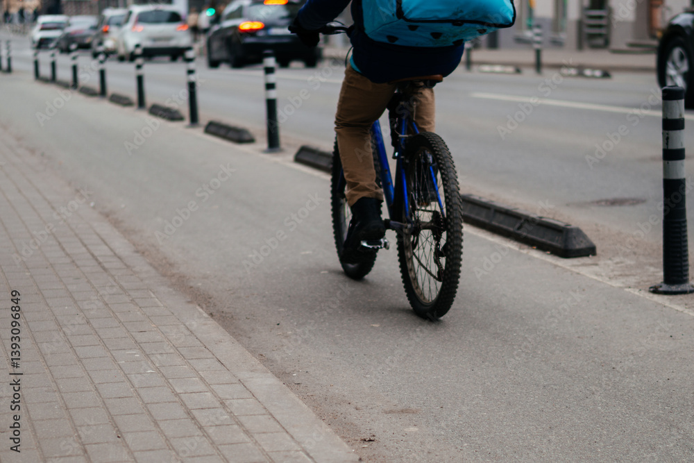 Fototapeta premium A dedicated bicycle lane with a clear road marking and directional arrow, emphasizing urban cycling infrastructure and sustainable transportation