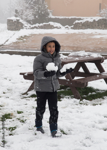 Child playing in snowballs