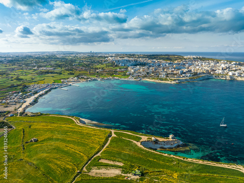 Drone aerial view of south part of Malta island. Green hills, fields, rocks and cliffs