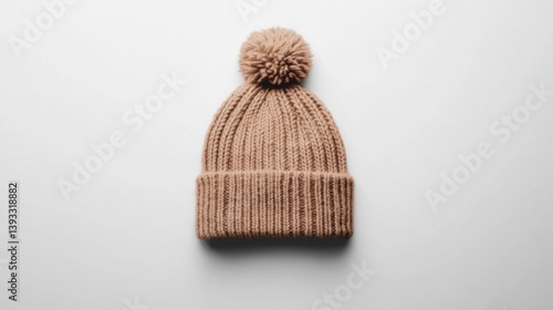 Knit winter beanie in neutral beige placed in the center of a white background, flat layout with clear details
