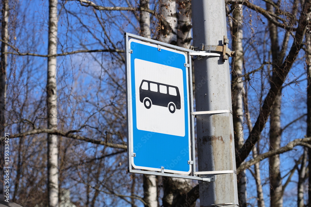 A street sign with blue and white colors mounted on a metal pole, great for urban or cityscape backgrounds.