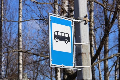 Obraz na płótnie A street sign with blue and white colors mounted on a metal pole, great for urban or cityscape backgrounds. w salonie