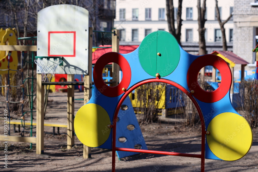 Colorful playground structure with a basketball hoop.