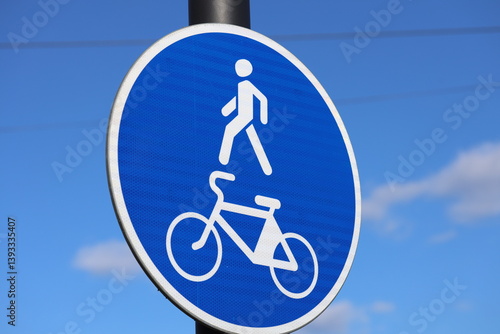 Obraz na płótnie A person riding a bicycle near a street sign. w salonie