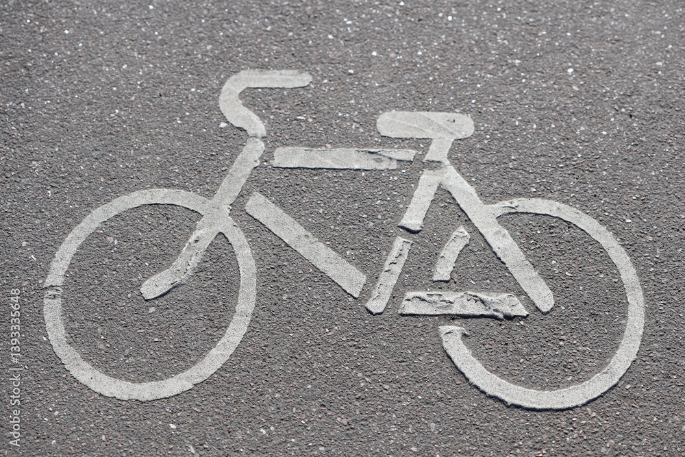 A colorful bicycle painted on the ground in a parking lot, perfect for use as an illustration or design element.