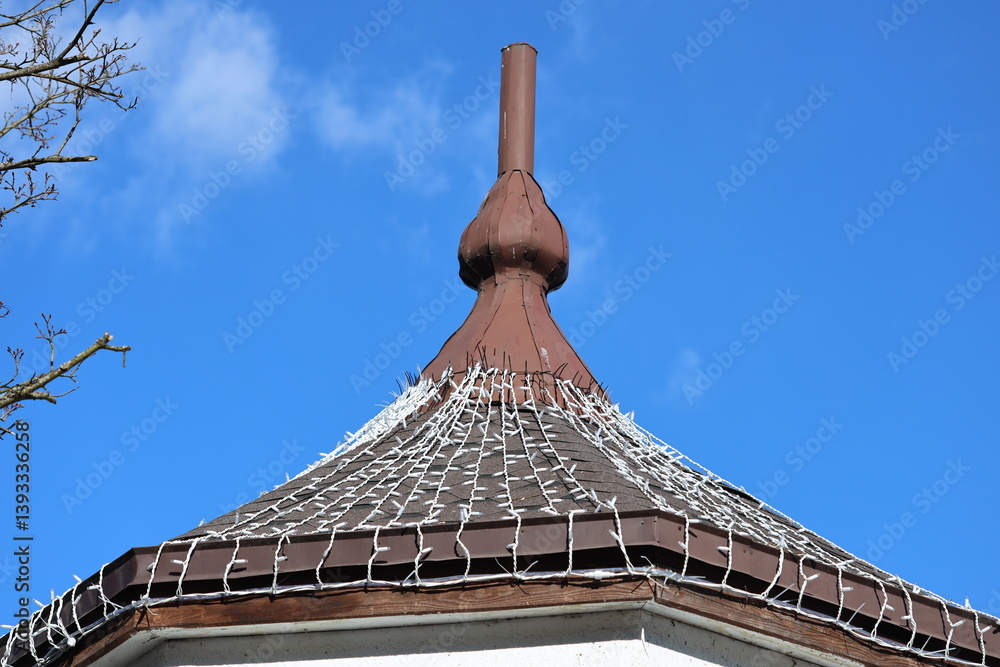 A clock tower at the top of a building with a prominent clock face.