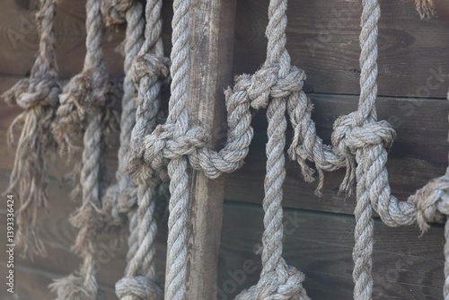 Obraz na płótnie A bunch of rope hanging on the side of a building, potential for climbing or support. w salonie
