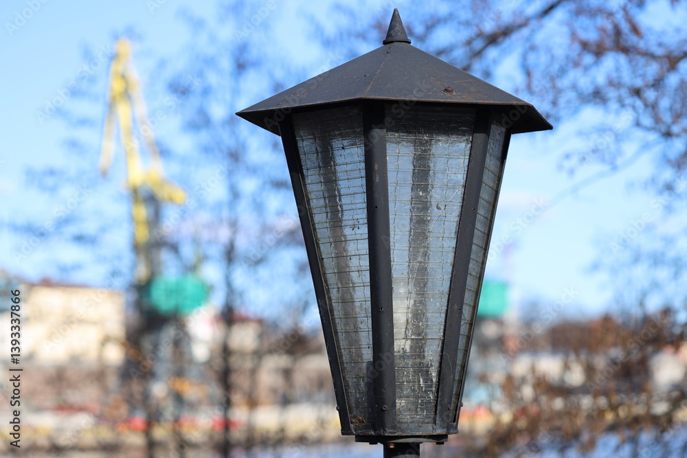 Streetlight beside a body of water, ideal for urban or coastal scenes.