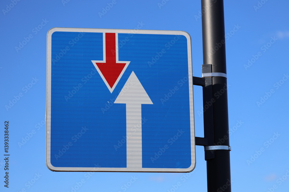 A blue street sign with an arrow pointing upwards, often used for directions and navigation.