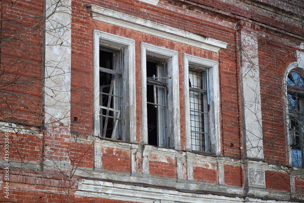 A classic brick building exterior featuring a window and clock.