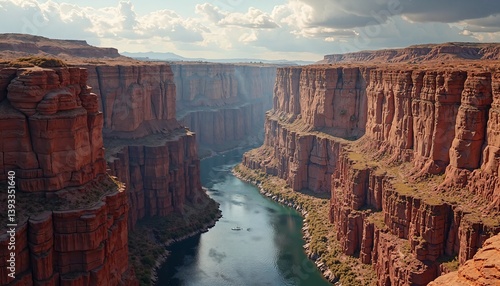 Majestic Canyon: Towering Reddish-Brown Cliffs Over a Serene River Flow, Under a Partly Cloudy Sky
