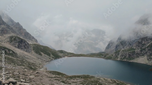 A serene mountain lake surrounded by towering peaks