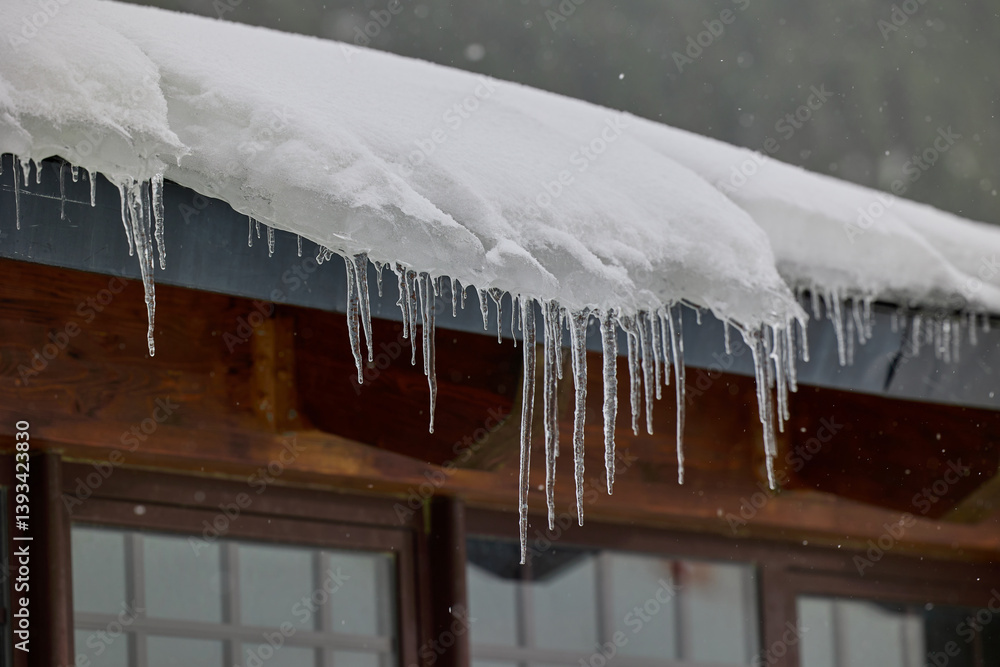 Icicles on the roof of a house in the Pyrenees, Cerler, Spain Icicles on the roof of a house in the Pyrenees, Cerler, Spain
