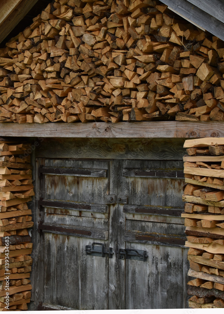 Naklejka premium wooden house with firewood close up
