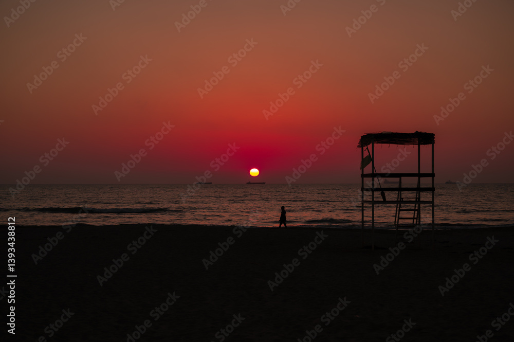 Scenic sunset over the sea in Albania. Vibrant sky with warm orange and pink hues reflecting on the calm water. Scenic sunset over the sea in Albania. Vibrant sky with warm orange and pink hues reflecting on the calm water.