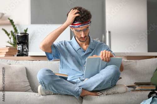 Stressed male student readi...