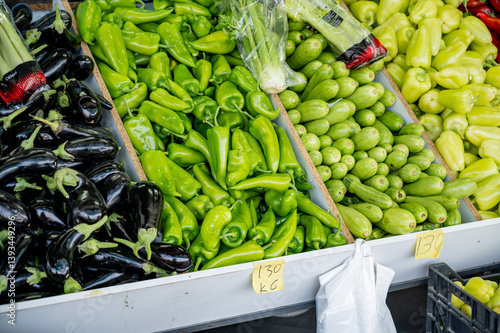 Boxes of vegetables at a street market. Fresh peppers, eggplants, zucchini.