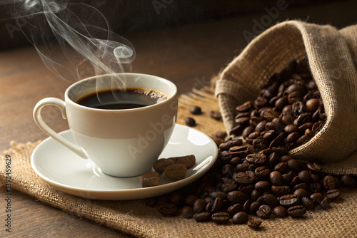 A steaming cup of dark, rich coffee, inviting warmth and comfort, nestled amongst a burlap sack overflowing with roasted beans, casting a warm, inviting glow.