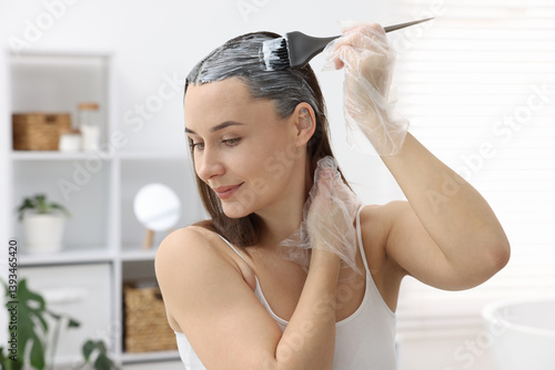 Photography Beautiful woman dyeing her hair at home