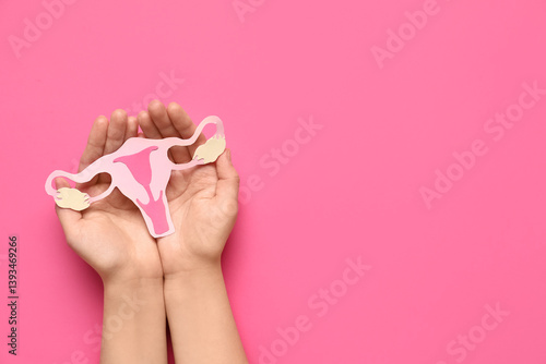 Obraz na płótnie Female hands with paper uterus on pink background, closeup w salonie