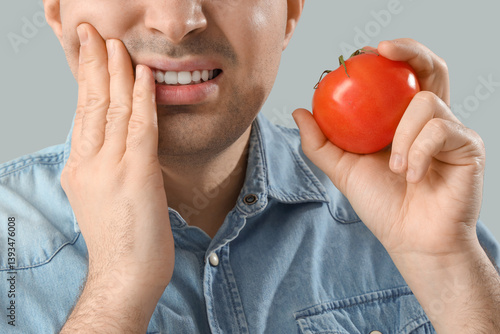 Young man with tomato suffe...