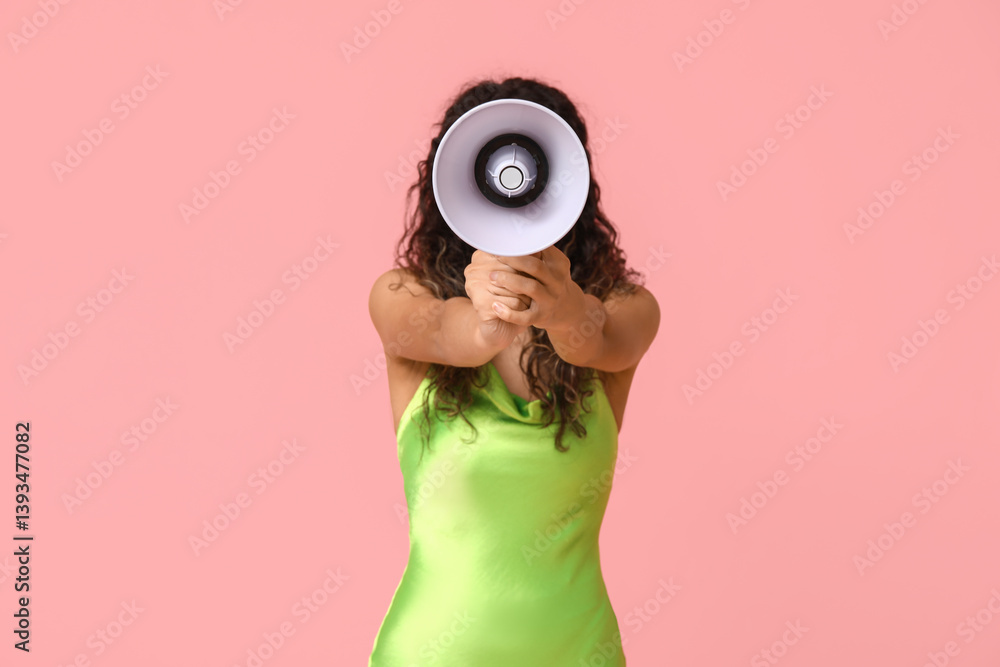Fototapeta premium Young African-American woman with megaphone on pink background