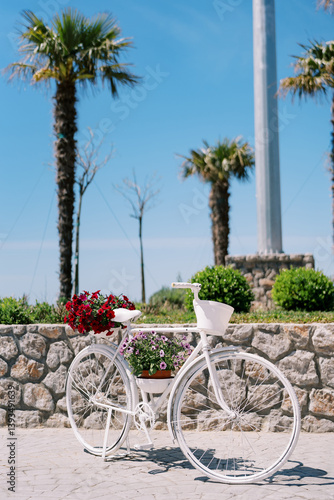 Wallpaper Mural White bicycle with flowers in pots stands near the stone fence of the park Torontodigital.ca