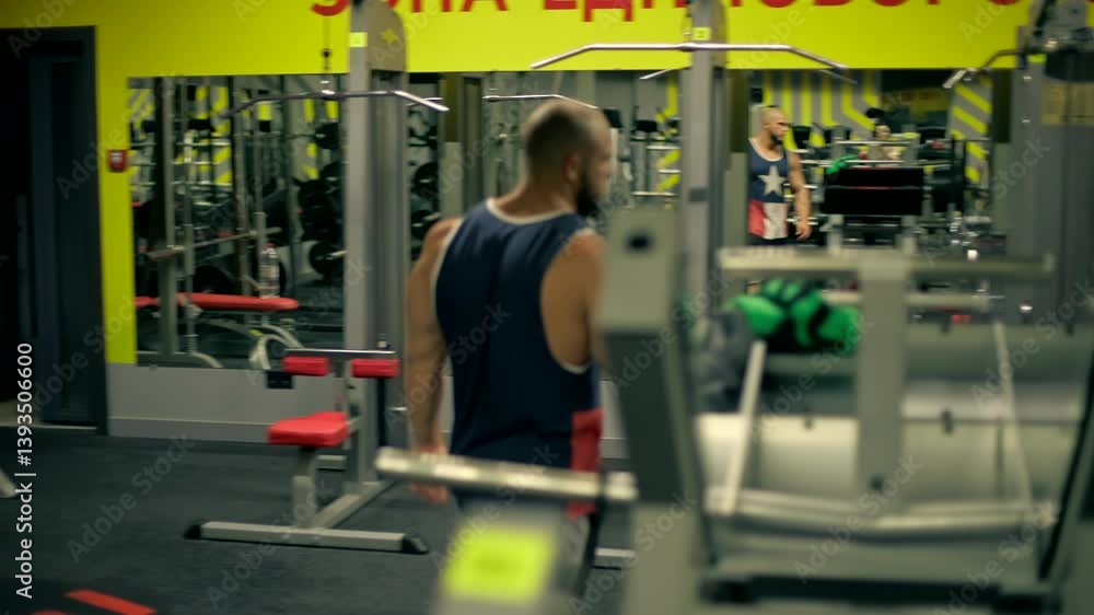 In vibrant gym setting bald athletic man beard hangs weights on leg press machine. His determined expression showcases his commitment fitness. In vibrant gym setting bald athletic man beard hangs weights on leg press machine. His determined expression showcases his commitment fitness.