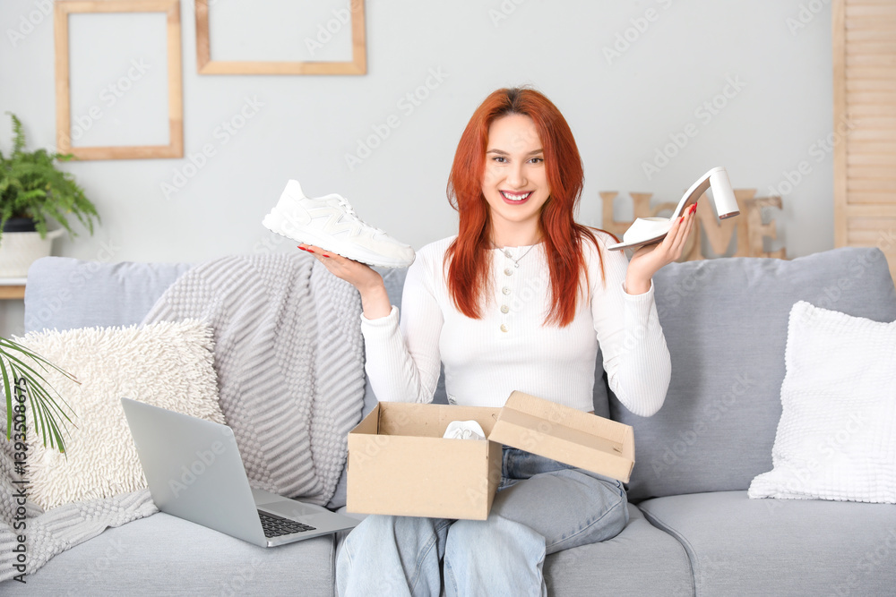 Young woman with laptop unpacking shoes at home Young woman with laptop unpacking shoes at home