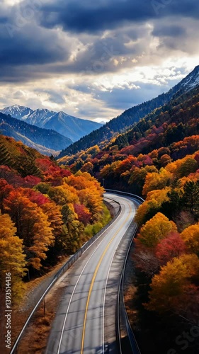 Vibrant autumn landscape with winding road and mountain backdrop in the afternoon