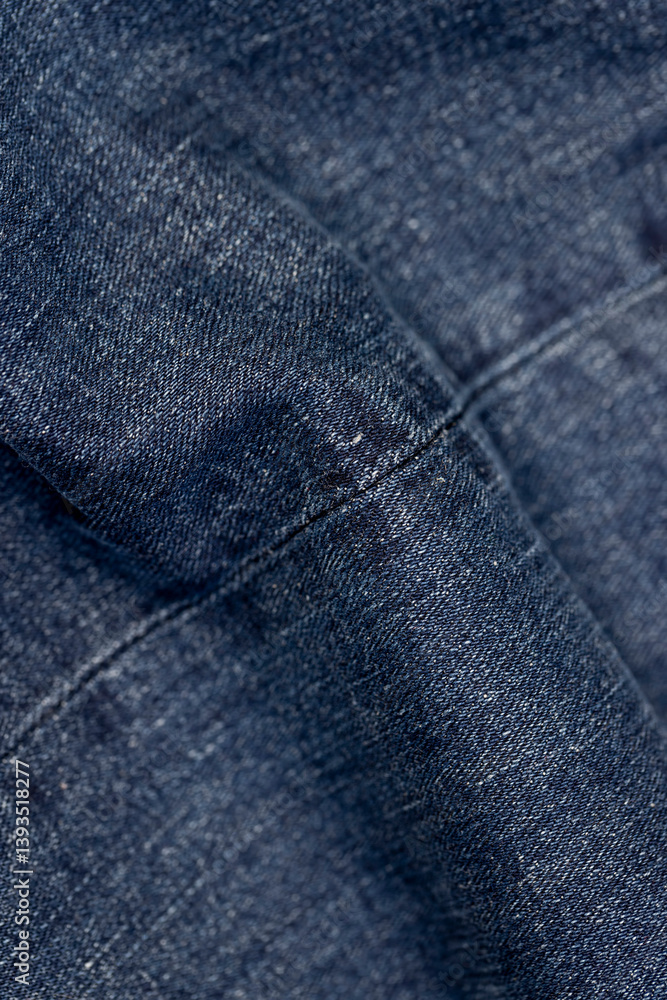 Fototapeta premium denim for the production of clothing, a piece of denim fabric for the production of clothing close up, sewn fabric