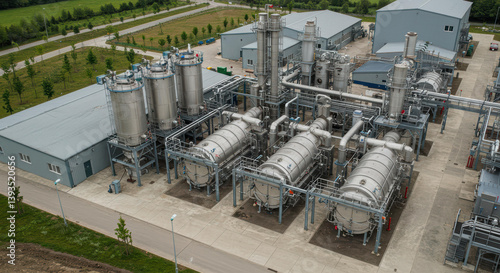 Modern biochar production facility with stainless steel pyrolysis chambers. Industrial plant for renewable energy. Eco-friendly approach to waste management with carbon capture technology