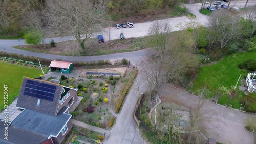 Wallpaper Mural Aerial view of a rural farm with greenhouses, solar panels on rooftops, a house with a garden, and surrounding fields and trees. The scene captures sustainable agriculture and countryside living. Torontodigital.ca