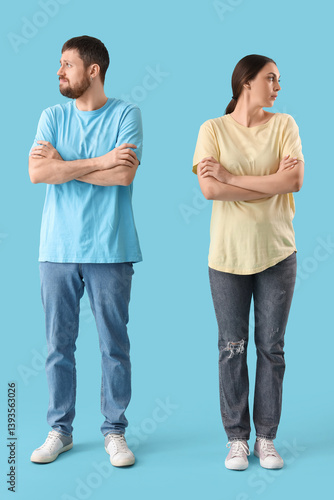 Couple standing back to bac...