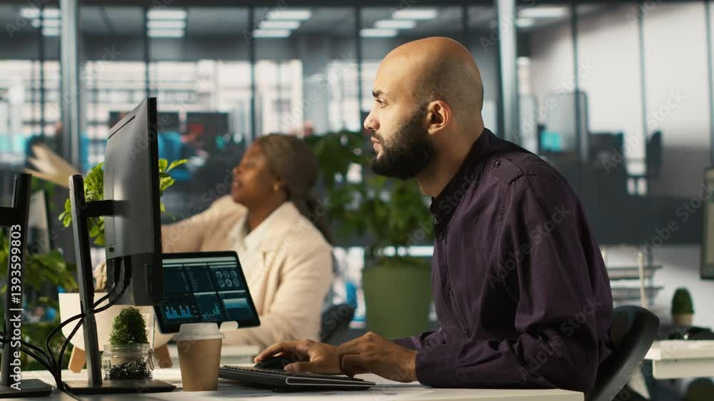 custom made wallpaper toronto digitalArab man in office reviewing financial graphs, analyzing key performance indicators. Middle Eastern employee in workspace looking over data trends and strategic insights, camera A