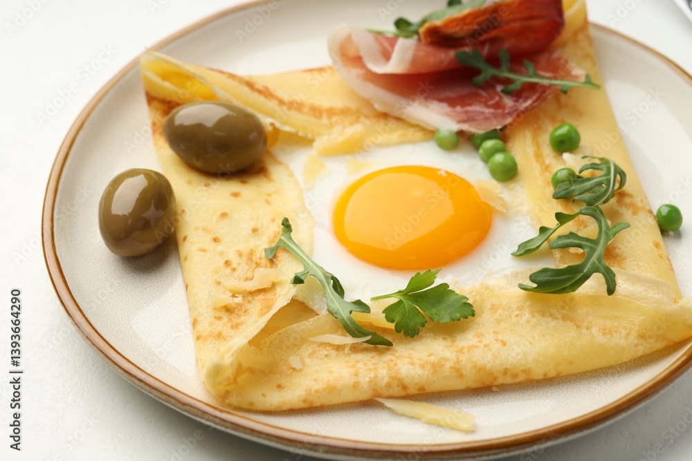 Delicious crepe with egg, bacon, olives and arugula on white table, closeup Delicious crepe with egg, bacon, olives and arugula on white table, closeup