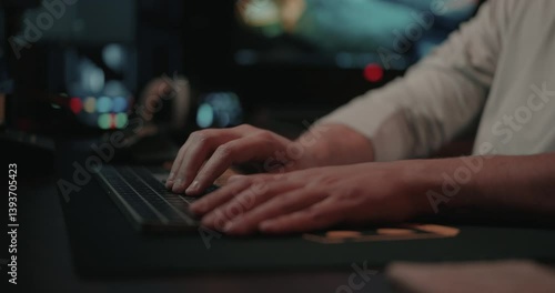 Film editor’s Hands typing on a keyboard and mouse