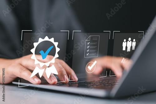 Businessman using laptop with quality assurance and document icon for ISO or International Standard Organization which related quality control and continuous improvement concept.