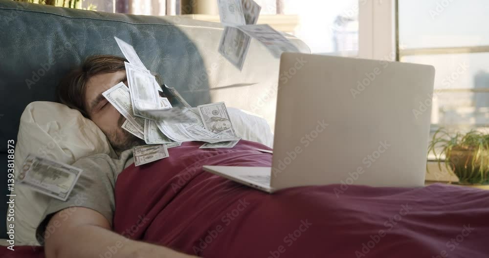 Man awakening from sleep by a flow of money flying from laptop. Man making money online while sleeping in bed. Earning money from comfort of bed. Lazy man passive income, easy money concept. Investing