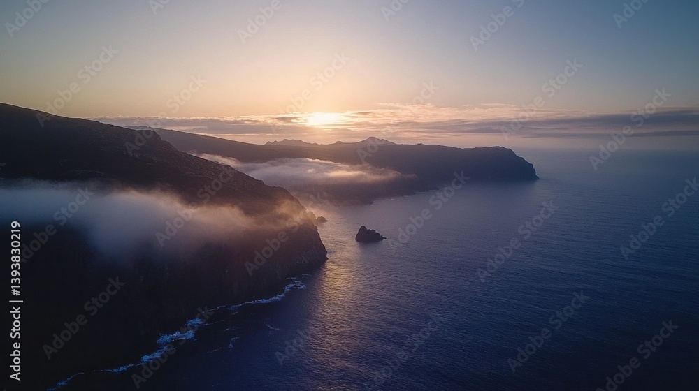 Fototapeta premium Tranquil Ocean Surface at Sunrise with Misty Coastal Landscape