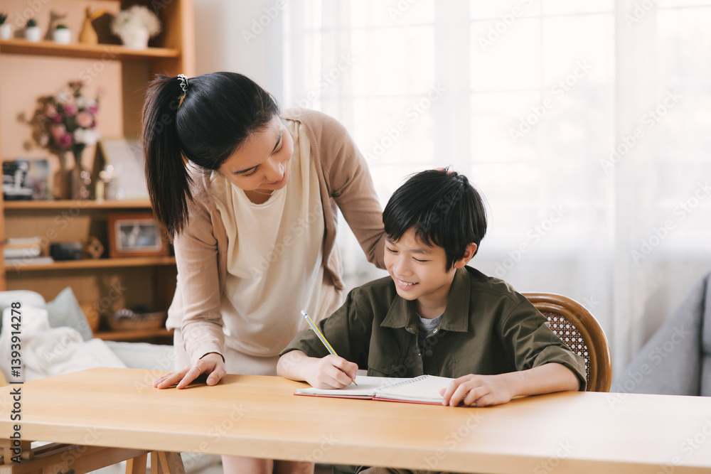 Smiling Asian mother and son bonding while studying at home desk. The room's cozy atmosphere warmth, love, and family inspiration. Ideal for portraying familial relationships and educational moments. Smiling Asian mother and son bonding while studying at home desk. The room's cozy atmosphere warmth, love, and family inspiration. Ideal for portraying familial relationships and educational moments.